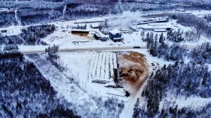 Ilmakuva Imatran Lämmön laitoksesta. Reunoilla näkyy metsää, keskellä lämpölaitoksen rakennus, hakekasoja ja energiapinoja.