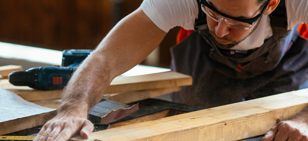 Kuvassa puuseppä työssä.